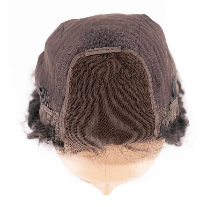 Top close up view of the cap of a messy curl transparent closure wig.