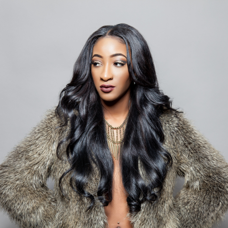 Lady wearing a fur coat wearing a HD body wave lace front wig